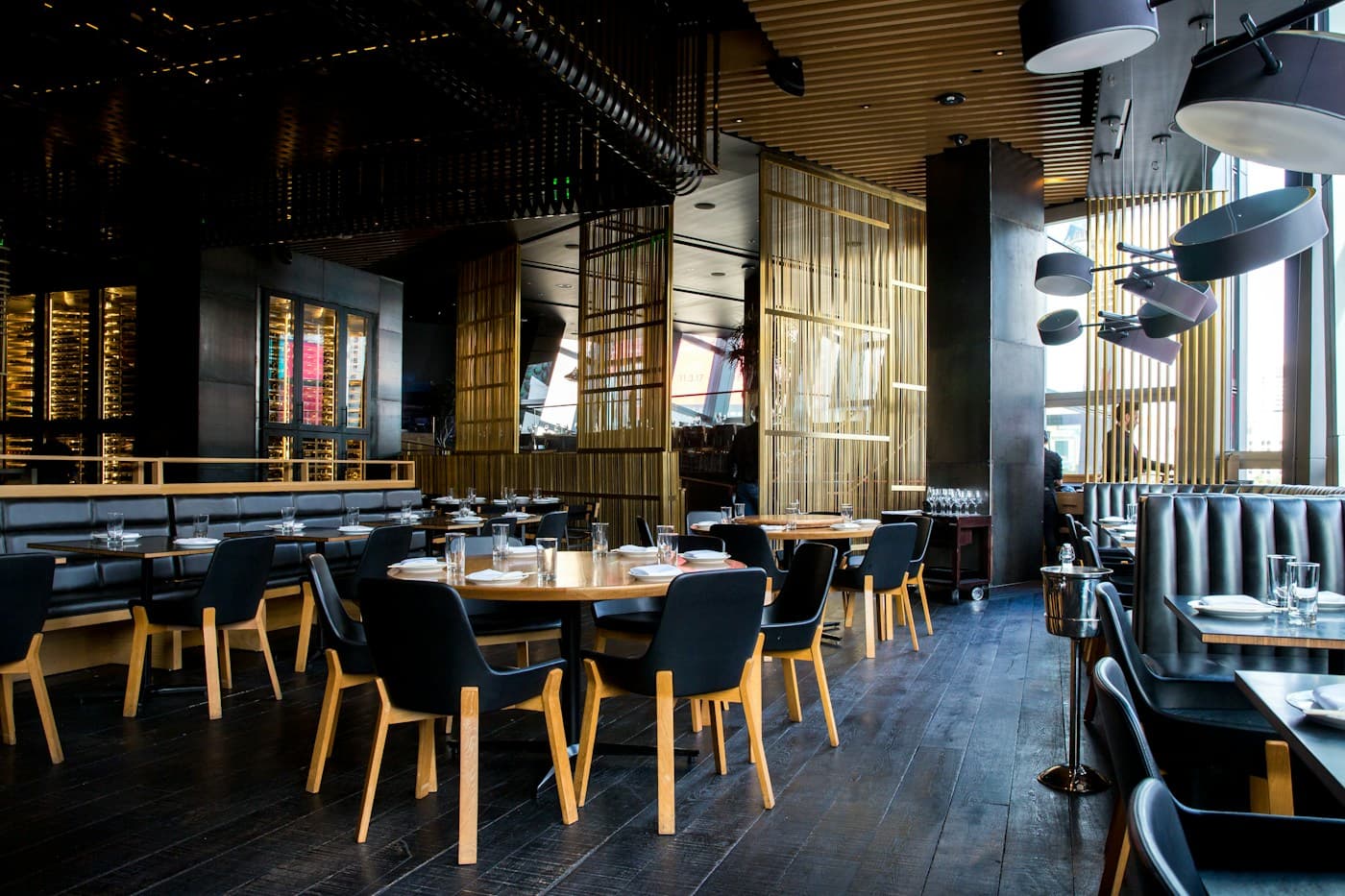 Warm restaurant interior with dining tables and pendant lighting